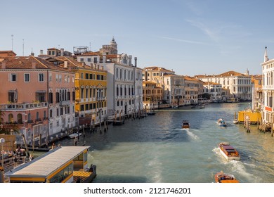 View on Grand Canal with vaporetto and gondolas in Venice. Venetian water transportation concept. Idea of traveling Italy. Cityscape in autumn sunny day