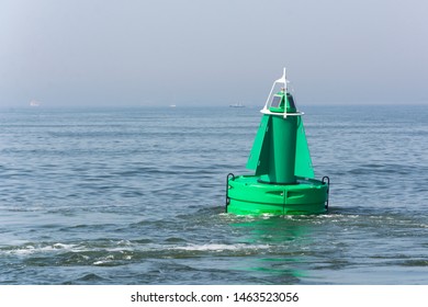 View On A Green Buoy In The Sea, A Device To Safeguard Ships And Boats. It Shows The Way Through The Water, So That Safety Comes First. 
It Is A Floating Navigation Device, With A Solar Cell On Top