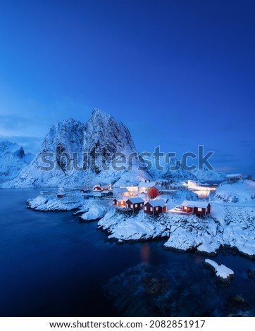 View on the house in the Hamnoy village, Lofoten Islands, Norway. Landscape in winter time during blue hour. Mountains and water. Travel image