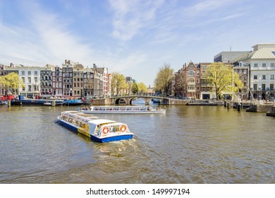 View on the houseboats with cruiseboat in Amsterdam the Netherlands