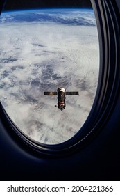 View On ISS Progress Resupply Ship, View Out From A Passenger Window On The SpaceX Crew Dragon. Docking Maneuver Near The Space Station. Elements Of Image Furnished By NASA.