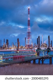 View On Large Petrochemical Production Plant On Riverbank At Twilight, Port Of Antwerp