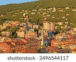 View on Lerici hill and the colouorful city centre in the Gulf of La Spezia in Liguria, Italy on a sunny summer evening with blue sky