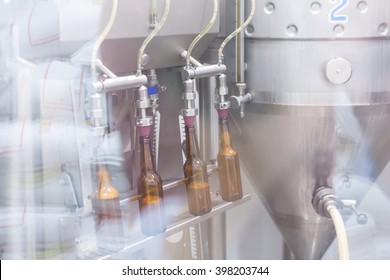 View on machine behind glass for bottling beer on a craft process
