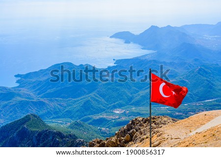 View on Mediterranean sea and hills from summit of Tahtali mountain. Turkish flag on foreground