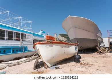 View On Motorboats On In A Dry Boat Storage Facility Against Blue Sky .Old Fishing Boat In A Dry Dock