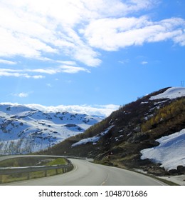 View On Mountains And Curvy Road In Spring Norway