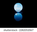 View on the ocean from a pipe or round shape hole with reflection inside the pipe. Abstract nature concept. Blue cool tone. Artificial framing of nature.