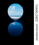 View on the ocean from a pipe or round shape hole with reflection inside the pipe. Abstract nature concept. Blue cool tone. Artificial framing of nature.