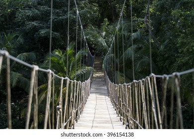 View On Old Wooden Dangerous Rope Bridge In Deep Lush Green Jungle Forest Outdoor On Natural Background With No People, Horizontal Picture