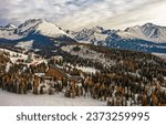 View on panorama of High Tatras with hotel and lookout tower during winter, High Tatras, Strbske Pleso, Slovakia, Europe
