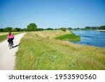 View on a path following the river Loire with cyclists in summer