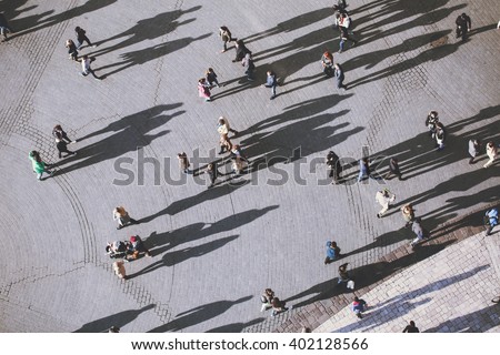 View on people from the tower of St. Mary's Church, Kosciol Mariacki. Background of people with lolg shadows. top view.