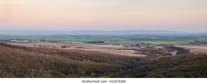 View on the plain and the mountains in the distance at sunset