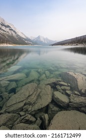 View on pristine alpine lake with clear water and mountain on its end, vertical, Jasper NP, Canada
