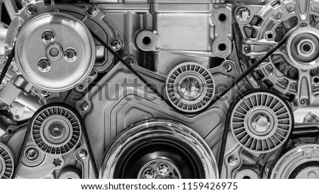 View on pulley and belts on a car engine.
