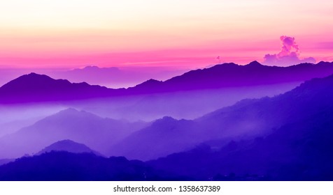 View On Purple Sunset In The Mountains