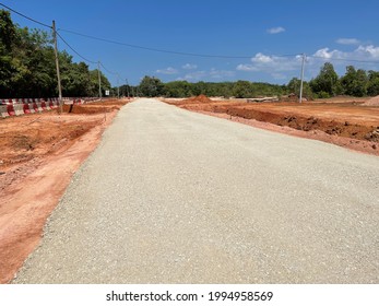 The view on a road that has been placed and compacted crusher run or subbase. Subbase is the layer of aggregate material laid on the subgrade, on which the base course layer is located. 