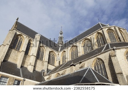 View on roofs, windows, tower of a large, old church, named Grote kerk or Sint-Laurenskerk (1470–1498) of the Dutch city of Alkmaar. October, Netherlands