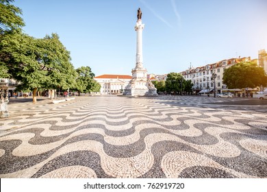 View on the Rossio square with column monument during the sunrise in Lisbon city, Portugal