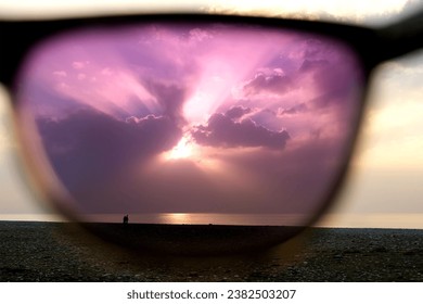 View on seascape sea and sunset sky through polarizing purple sunglasses. Scenery landscap. Man looking at sea coast. Travel, tourism, vacation, new vision, changing consciousness and thinking. - Powered by Shutterstock