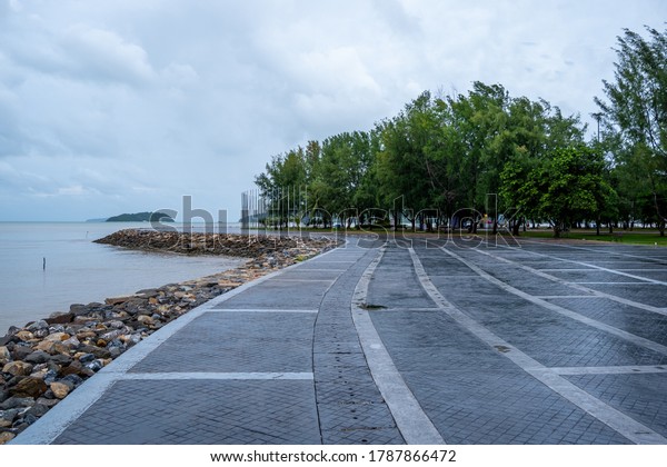 View on Seaside walk way : Waters of Phuket Sea,\
Walking Side, Trees and\
Rocks.