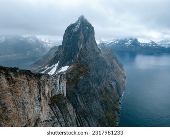 View on Segla, from Hesten trekking. travel through fjords on Senja island, Norway. Hiking and vacation in Senja and Lofoten islands. Inclement weather, storm clouds in the sky.
