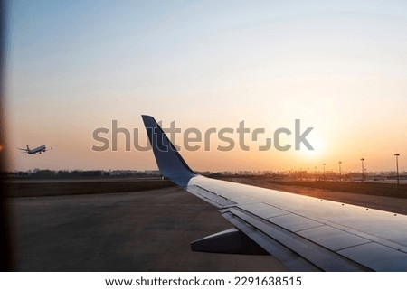 View on sunset and airplane wing from the inside