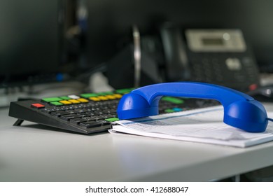 View On Table With Keyboard, Handset And A Blotter. Stationary Phone On Background.