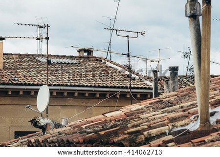 View on tiled roofs with satellites