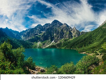 View on the turquoise color lake between high and rocky mountains. Beautiful alpine landscape.  - Powered by Shutterstock