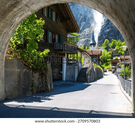 view on typical architecture of alpine village in Lauterbrunnen with church in Switzerland