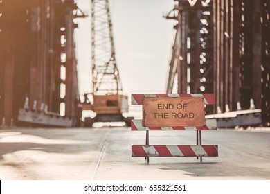 View on unfinished construction on the street. Warning about the end of the road.