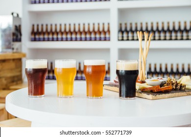 View On Variety Of Craft Beer In Glasses And Snack Board On Table