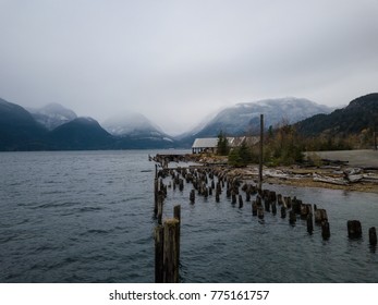 View On The Wooden Posts Overlooking Howe Sound Covered In Rain Clouds. Taken In Britannia Beach, North Of Vancouver, British Columbia, Canada.