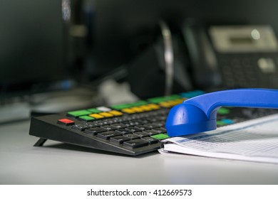 View On Workplace In A Trading Room With A Blotter, Handset And Keyboard.