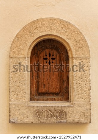 View of one of the many iconic wine windows, or Buchette del Vino found on the facade of buildings throughout the city of Florence