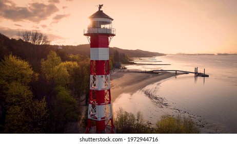 View onto the port of Hamburg at a landmark with the lighthous, located at the riverside of the riever Elbe with the beautiful beach, called Wittenbergen. - Powered by Shutterstock