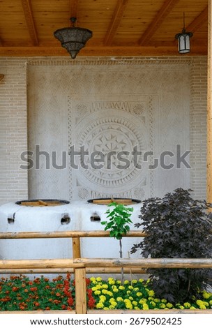 View of an open air kitchen with oven and flowers in Samarkand, Uzbekistan