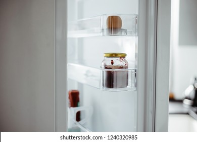 View Of The Open Fridge. Using The Fridge, Cooling The Food To Extend The Shelf Life For Consumption. Taking Food Out Of The Fridge At Home, Preparing Meals.