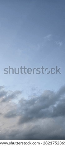 The view of the open sky with a combination of clouds and distinctive color gradations at nightfall
