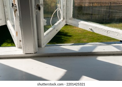 View From Open Window In The Village. White Old Wooden Windows With View On Blue Sky And Green Field. Symbol Of Insouciance, Freedom, Summer Atmosphere. Holiday House, Summer Cottage, Weekend Cottage.