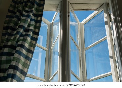 View From Open Window In The Village. White Old Wooden Windows With View On Blue Sky And Green Field. Symbol Of Insouciance, Freedom, Summer Atmosphere. Holiday House, Summer Cottage, Weekend Cottage.