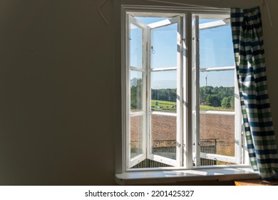 View From Open Window In The Village. White Old Wooden Windows With View On Blue Sky And Green Field. Symbol Of Insouciance, Freedom, Summer Atmosphere. Holiday House, Summer Cottage, Weekend Cottage.