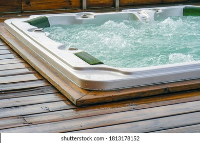 View of the open working hot tub. Pool cleaner during his work. - Shutterstock ID 1813178152