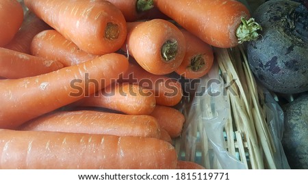 View of organic juicy bolero carrot and beetroot on the basket at local market or store. It is cylindrical carrots with blunt ends and little tapering from top to bottom. cooking, home kitchen Imagine de stoc © 