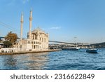 View of Ortakoy Mosque and the Bosporus in Istanbul, Turkey. The Bosphorus Bridge (the 15 July Martyrs Bridge) is visible in background.