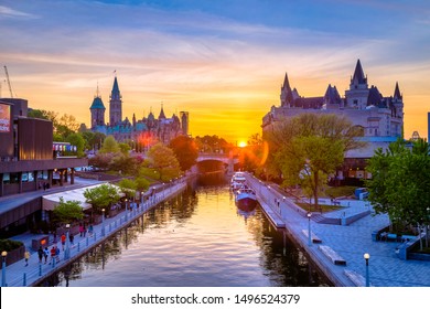 View of Ottawa city buildings and Rideau canal from Mackenzie King bridge during sunset