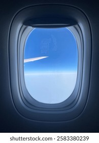 View out plane window during pretty day.