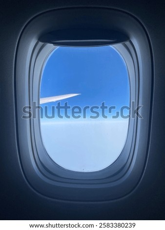 View out plane window during pretty day.